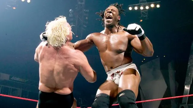 booker t hits rick flair with a clothesline 1402384212